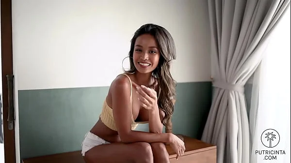 Putri Cinta, a nasty Asian babe, showing her teeny wet pussy