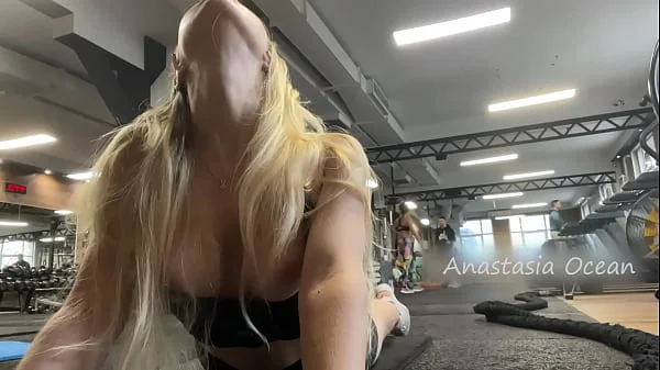 Naughty girl flashing tits in gym right next to the men’s company. Public.
