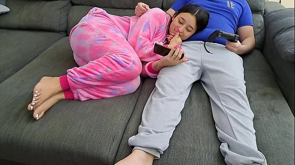 Stepsister sucks stepbrother and eats his sperm while he plays video games