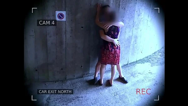 Young couple fucks in front of the garage exit and is caught by the surveillance camera