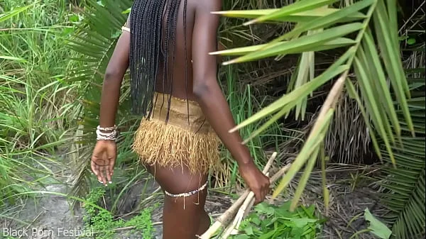 Hot African native woman cooking in the jungle