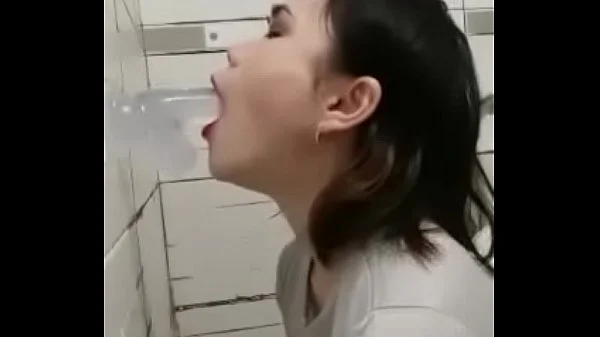 Asian deepthroating a dildo