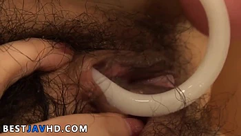 Horny Asian teen paws her hairy puss with fucktoys - spraying woman!