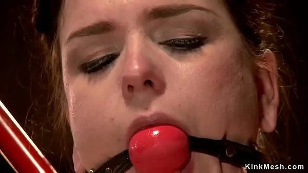 Brunette in tormented in bdsm chair