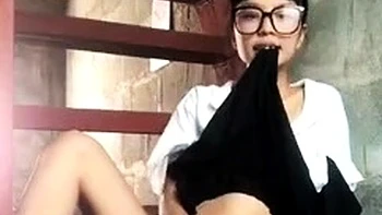 Asian teen plays with toys on webcam