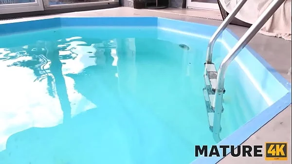 MATURE4K. Blonde mature woman gets it on with man by the outdoor pool