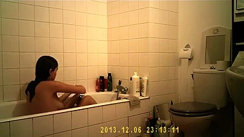 Brunette cutie enjoys a hot shower in the bathroom