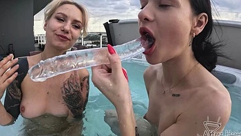 Two hot girls fucking in the jacuzzi, peeling off their clothes
